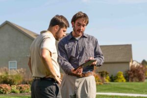 Lawn technician talking to customer