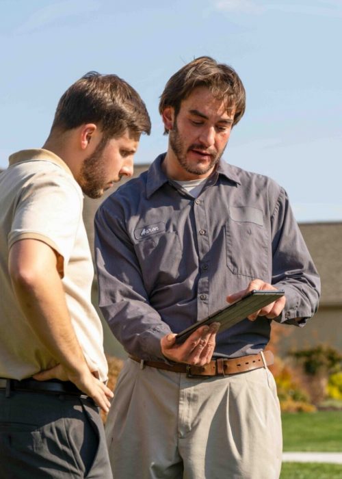 Lawn technician talking to customer